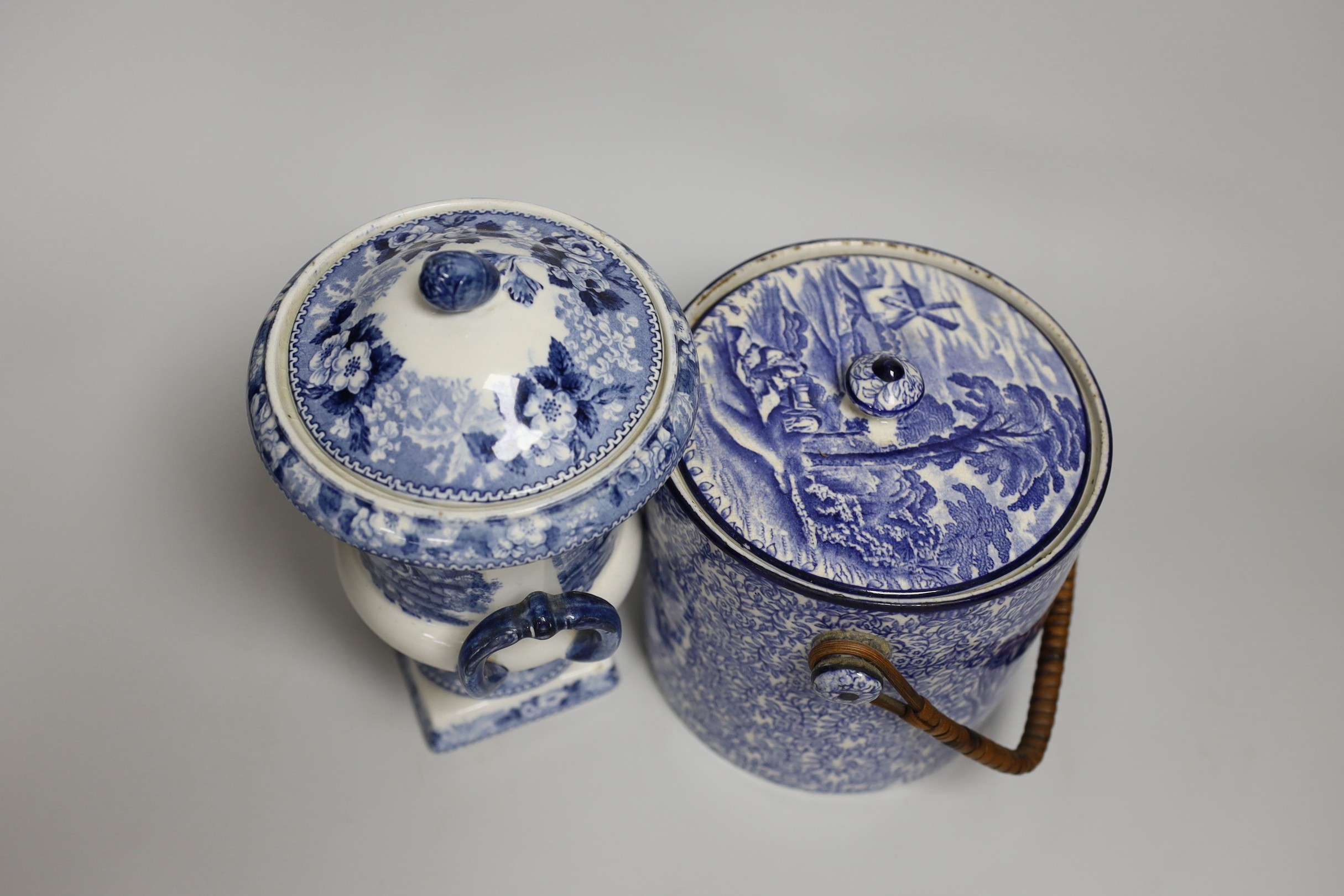 Blue and white pottery- A Victorian Willow pattern comport, a biscuit barrel and an urn with cover